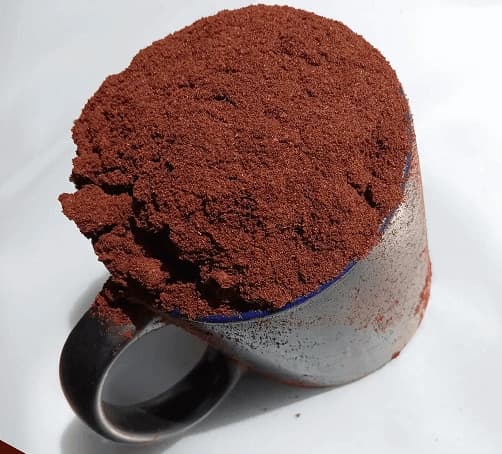 Madagascar vanilla bean powder in a bowl — fine dark speckled ground vanilla